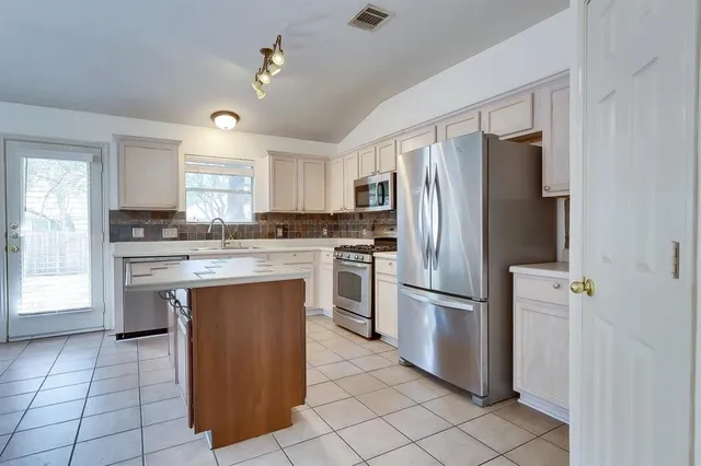 a kitchen with a refrigerator sink and oven