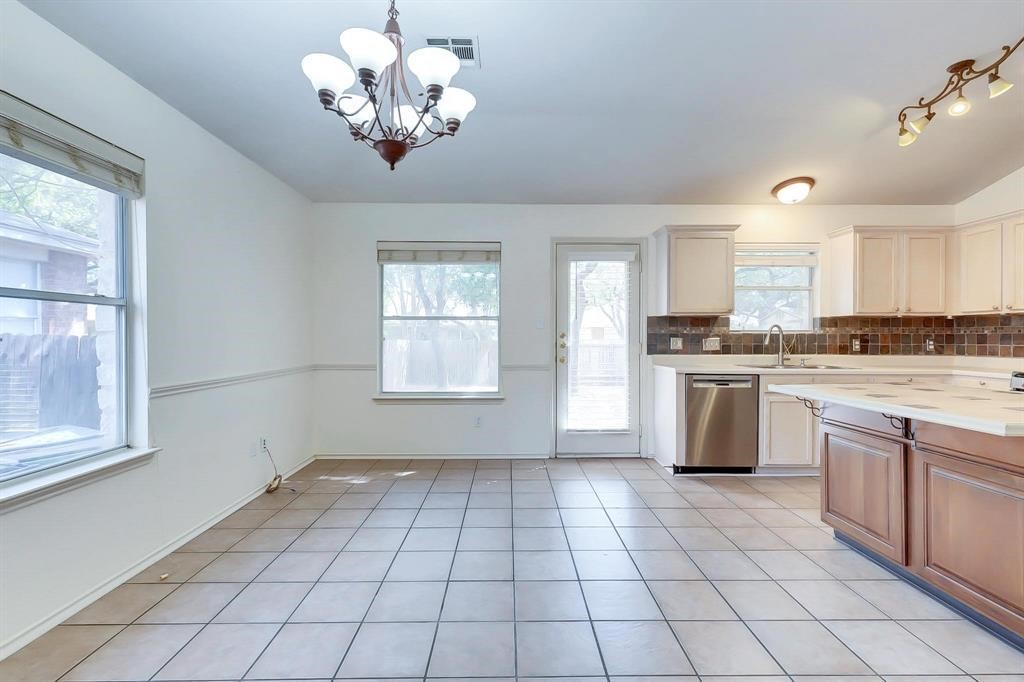 3337 Cantera Way Round Rock, TX 78681 - Photo 10 of 25 a kitchen with a stove a sink cabinets and a window