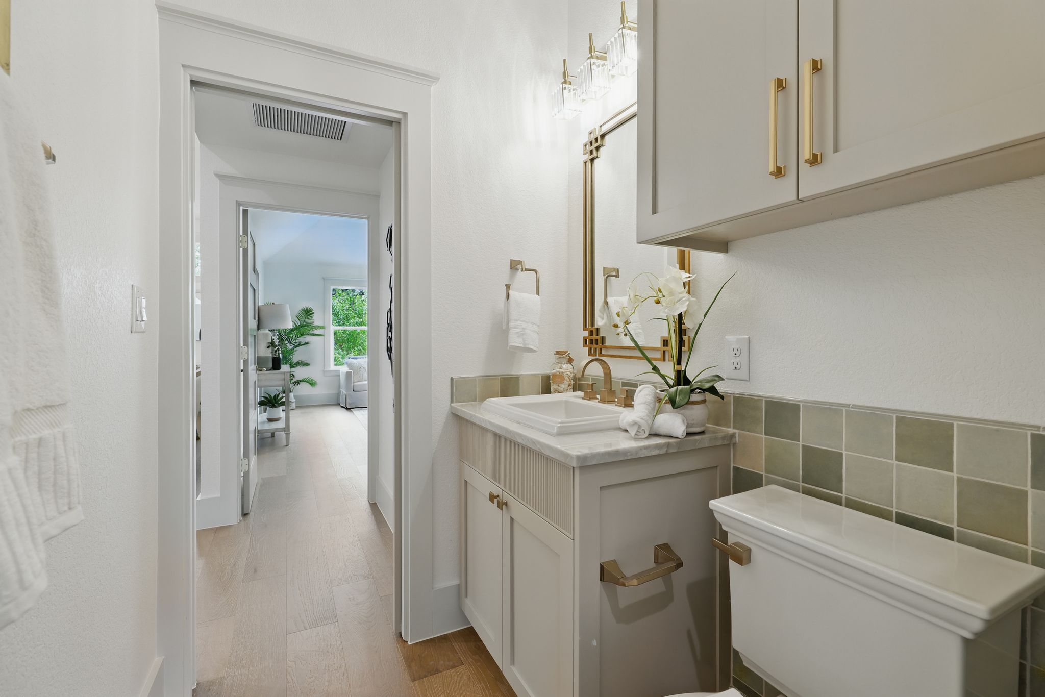 6905 Rudi Cove Austin, TX 78759 - Photo 19 of 36 Bathroom with vanity, wood finished floors, and tile walls