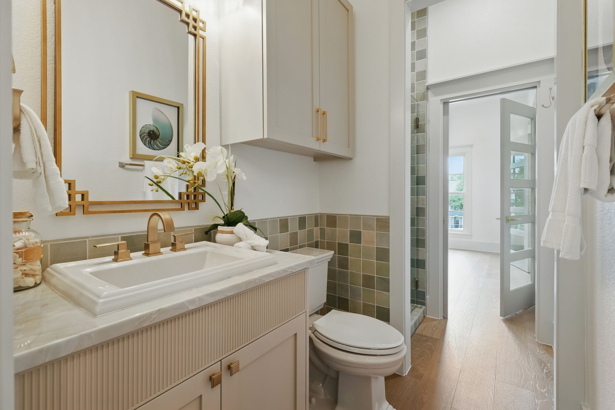 6905 Rudi Cove Austin, TX 78759 - Photo 20 of 36 Full bathroom with vanity, wood finished floors, tile walls, and a shower