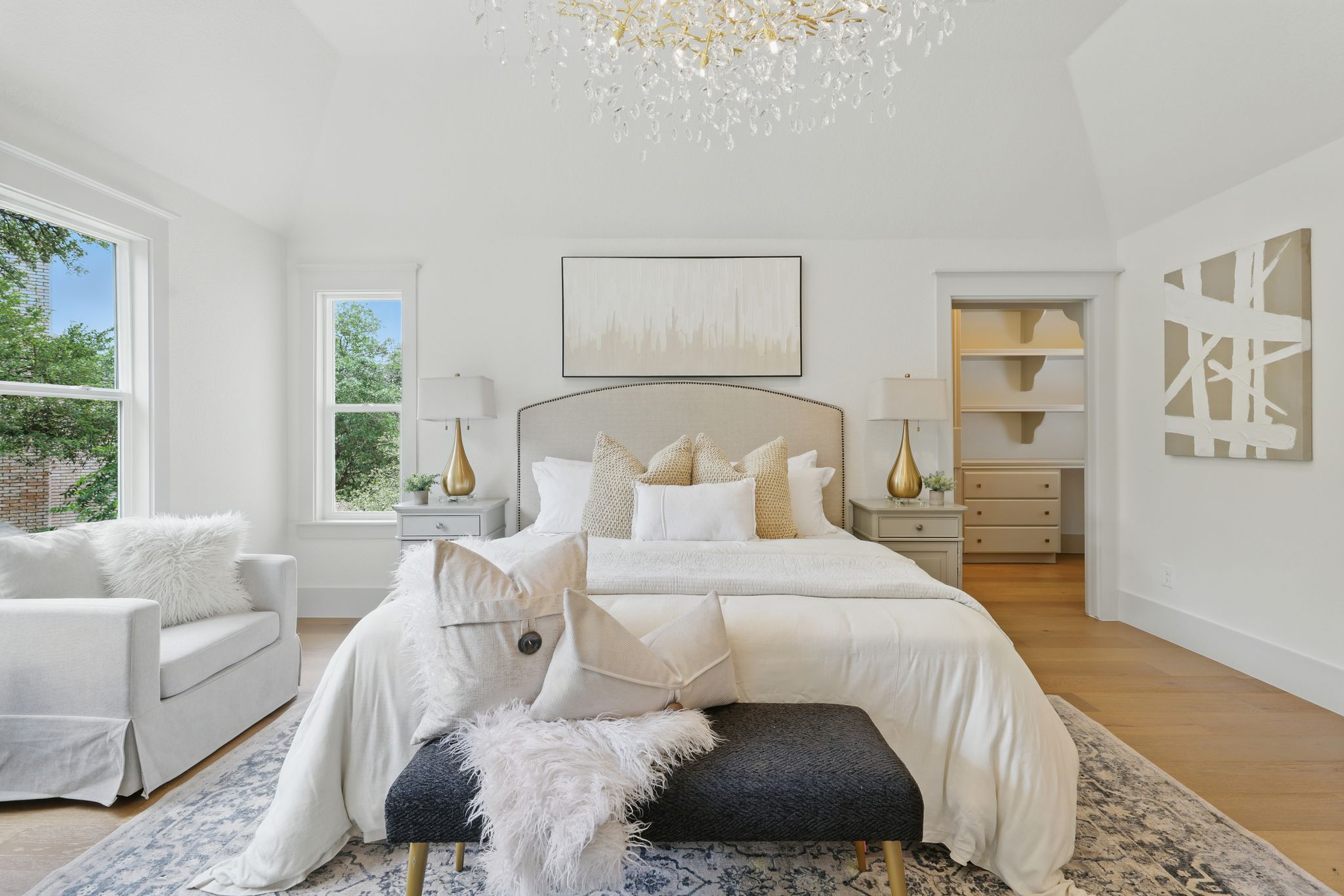 6905 Rudi Cove Austin, TX 78759 - Photo 23 of 36 Bedroom with a chandelier, light wood-style flooring, and high vaulted ceiling