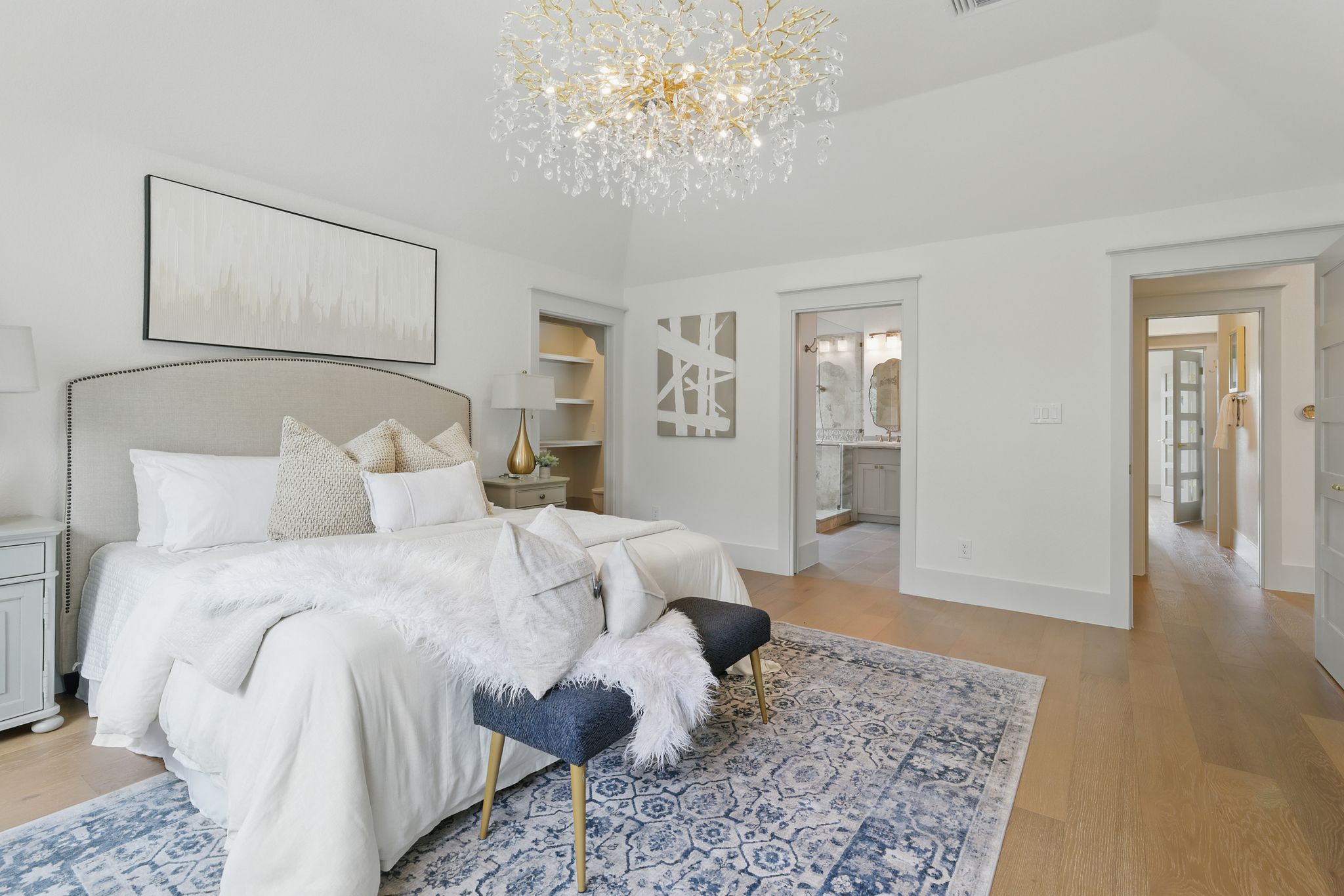 6905 Rudi Cove Austin, TX 78759 - Photo 24 of 36 Bedroom with a chandelier, light wood-style flooring, and ensuite bathroom