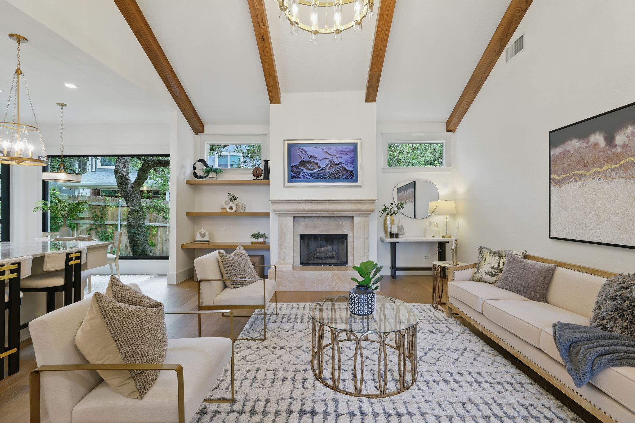 6905 Rudi Cove Austin, TX 78759 - Photo 9 of 36 Living room with a chandelier, a premium fireplace, wood finished floors, beam ceiling, and recessed lighting