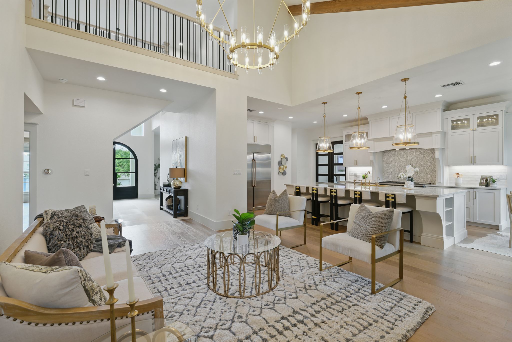 6905 Rudi Cove Austin, TX 78759 - Photo 10 of 36 Living room featuring light wood-style floors, a towering ceiling, a chandelier, and recessed lighting
