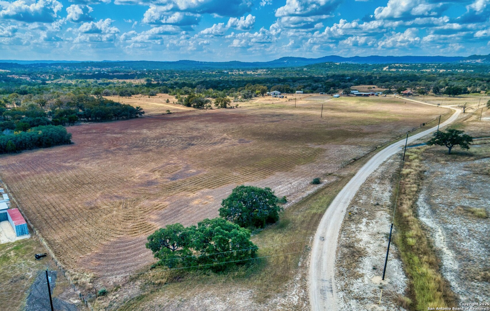 261 Watering Hole Trail Bandera, TX 78003 - Photo 18 of 24 a view of a dry yard with wooden fence