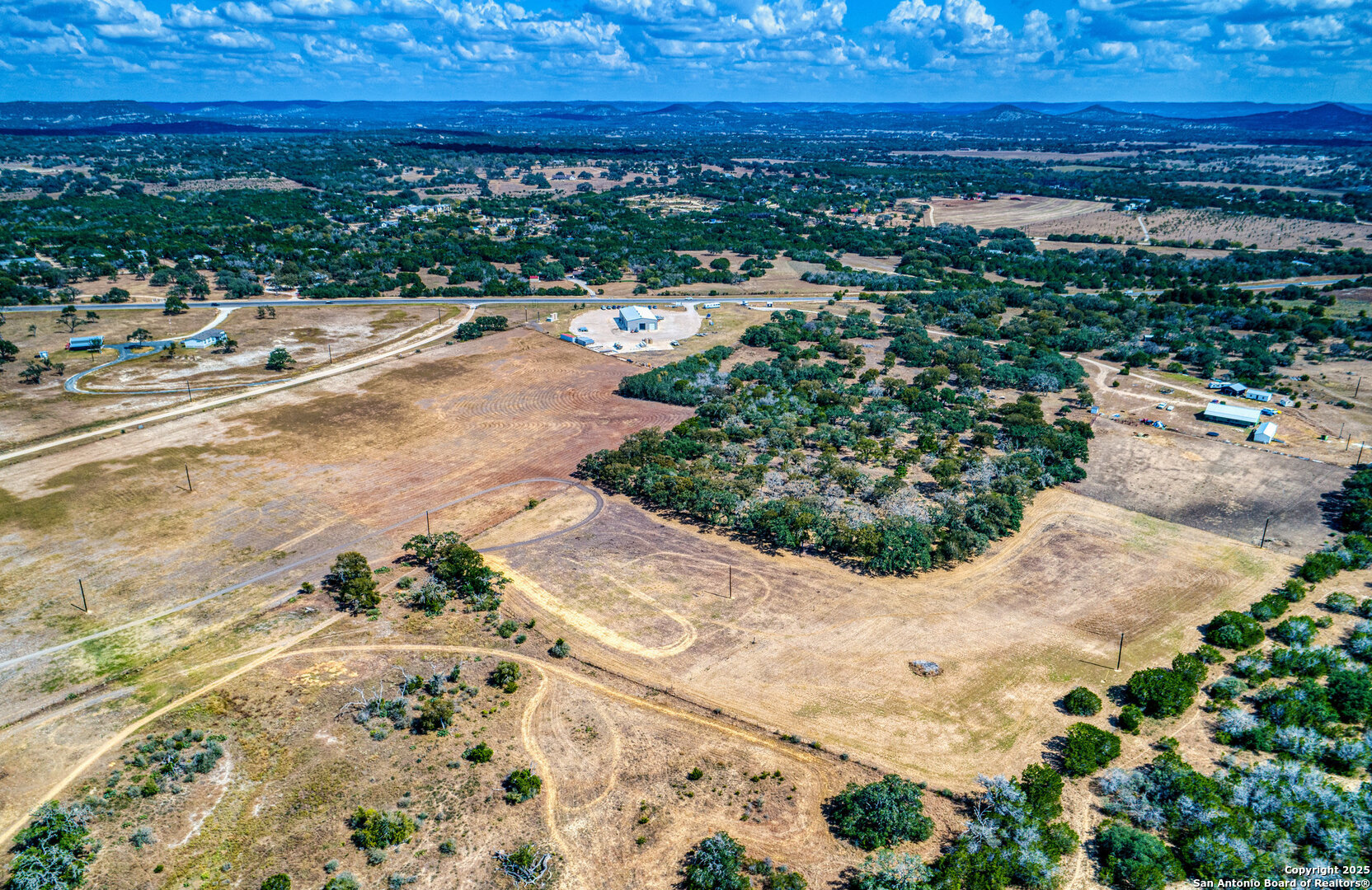 261 Watering Hole Trail Bandera, TX 78003 - Photo 22 of 24 a view of a yard with an ocean view