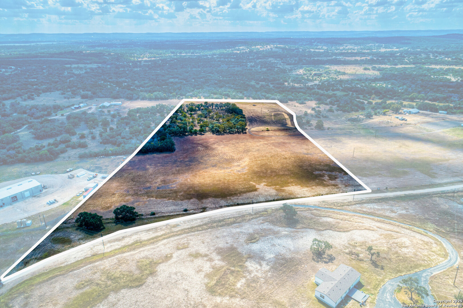 261 Watering Hole Trail Bandera, TX 78003 - Photo 7 of 24 a view of a dry yard with wooden floor