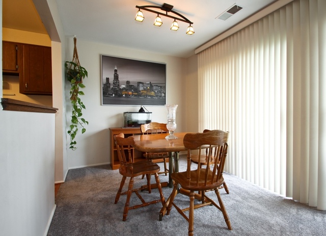 29 Stanton Court, Unit C2 Schaumburg, IL 60193 - Photo 3 of 9 a view of a dining room with furniture and window
