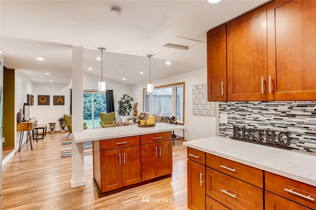 3427 Southeast 7th Street Renton, WA 98058 - Photo 14 of 32 a kitchen with large cabinets appliances and wooden floor