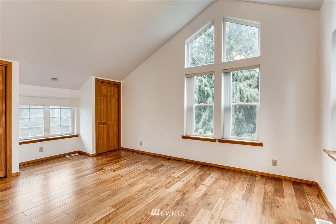 3427 Southeast 7th Street Renton, WA 98058 - Photo 24 of 32 an empty room with wooden floor and windows