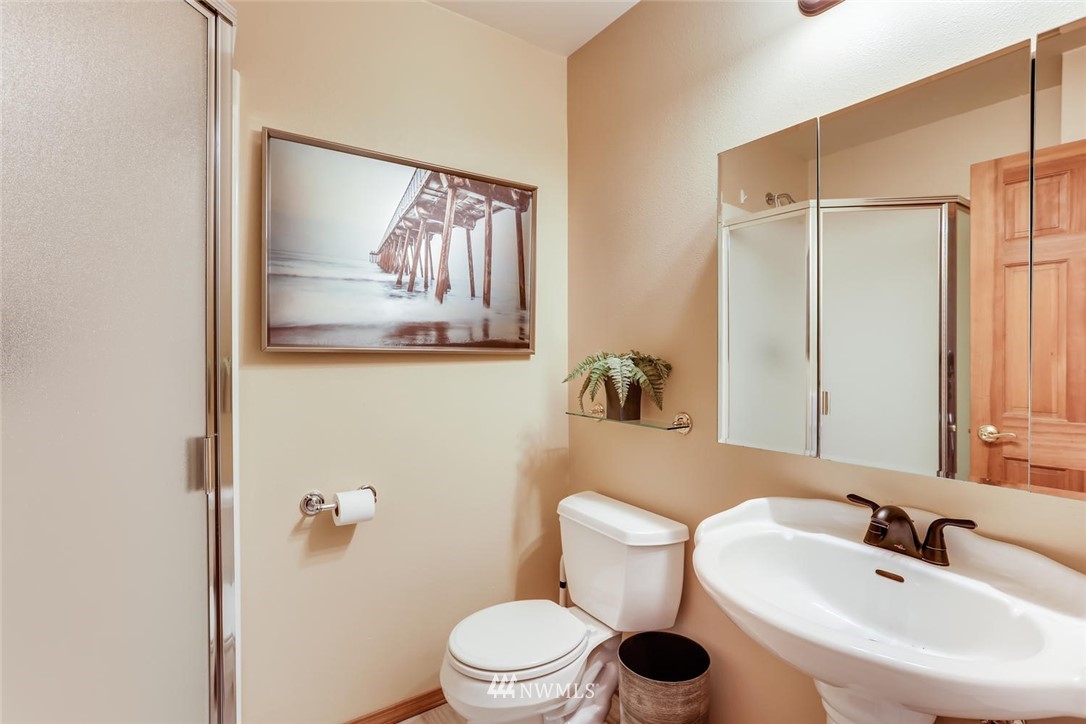 3427 Southeast 7th Street Renton, WA 98058 - Photo 27 of 32 a bathroom with a toilet sink and mirror