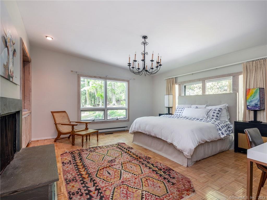 95 Shinar Mountain Road Washington, CT 06794 - Photo 11 of 28 a spacious bedroom with a bed and wooden floor