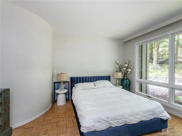 a bed sitting in a bedroom next to a window