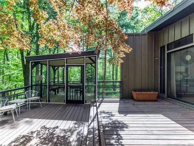 a backyard of a house with barbeque oven table and chairs