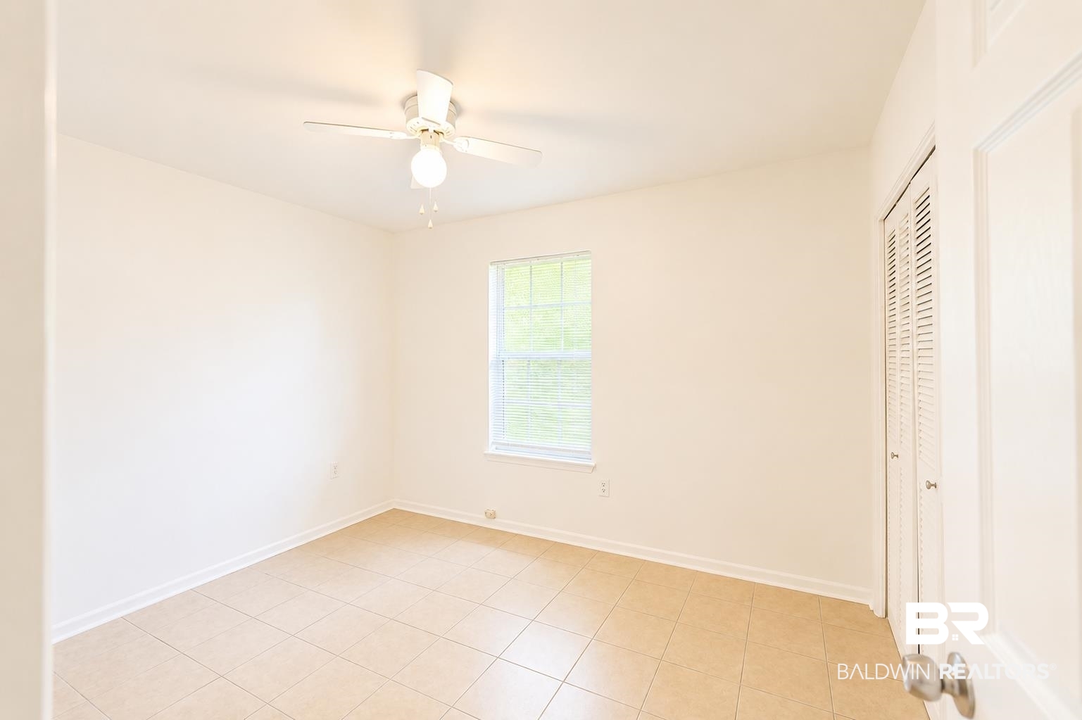 614 East Gate Circle Foley, AL 36535 - Photo 17 of 31 Neutral-toned room with light tile flooring, a window offering natural illumination, and a ceiling fan with integrated lighting