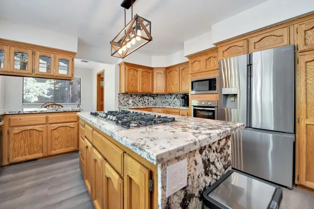 a bedroom with a bed next to a window with a flat screen tv