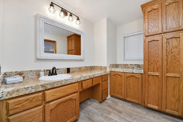 a kitchen with a stove and a wooden floor