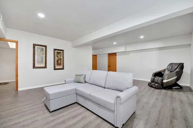 a view of a house with a yard and large trees