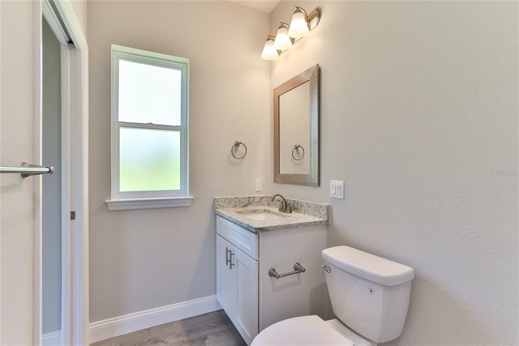 9 Seton Place, Unit A Palm Coast, FL 32164 - Photo 18 of 31 a bathroom with a toilet sink and mirror