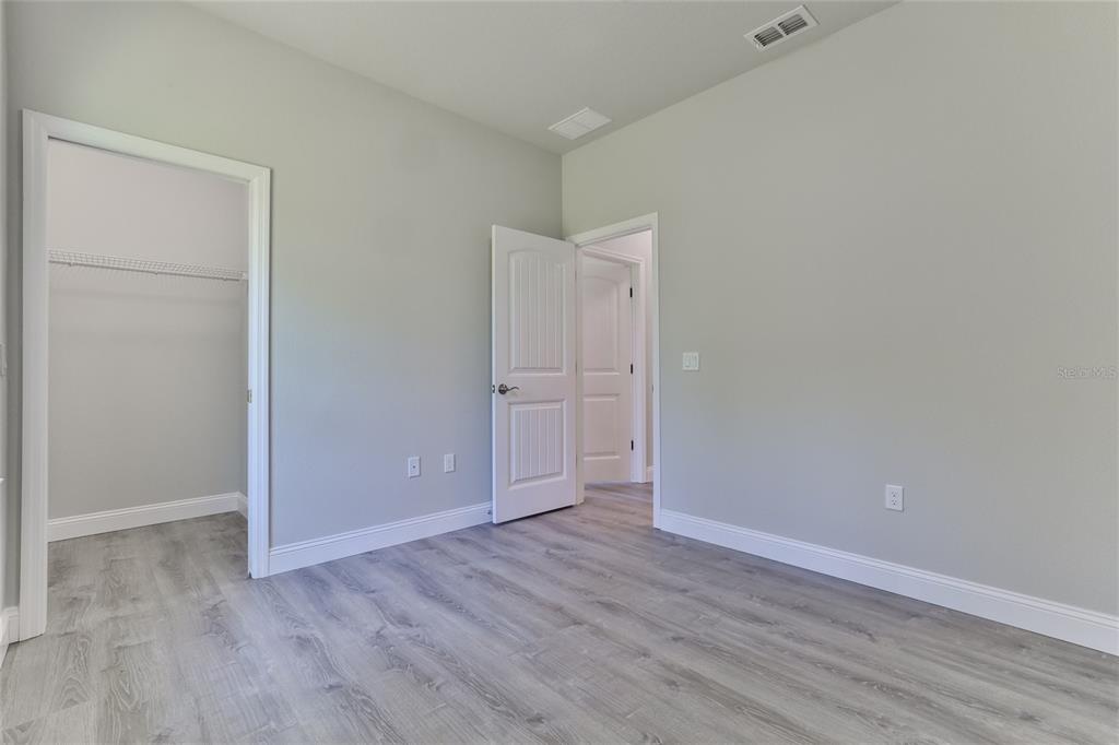 9 Seton Place, Unit A Palm Coast, FL 32164 - Photo 22 of 31 a view of an empty room with wooden floor