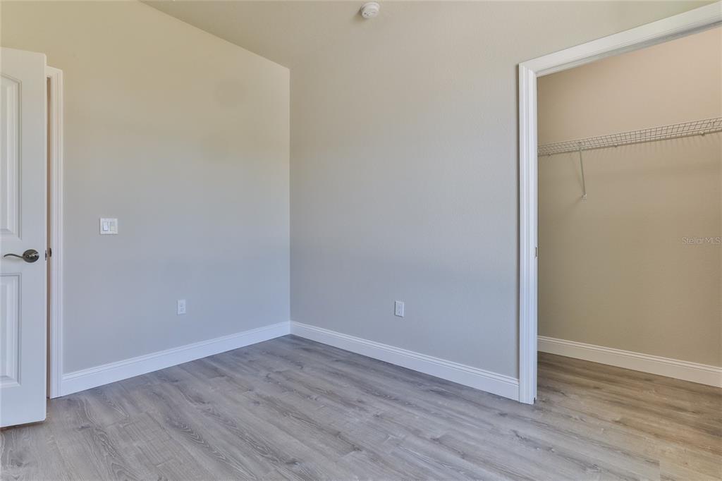 9 Seton Place, Unit A Palm Coast, FL 32164 - Photo 25 of 31 a view of an empty room with wooden floor