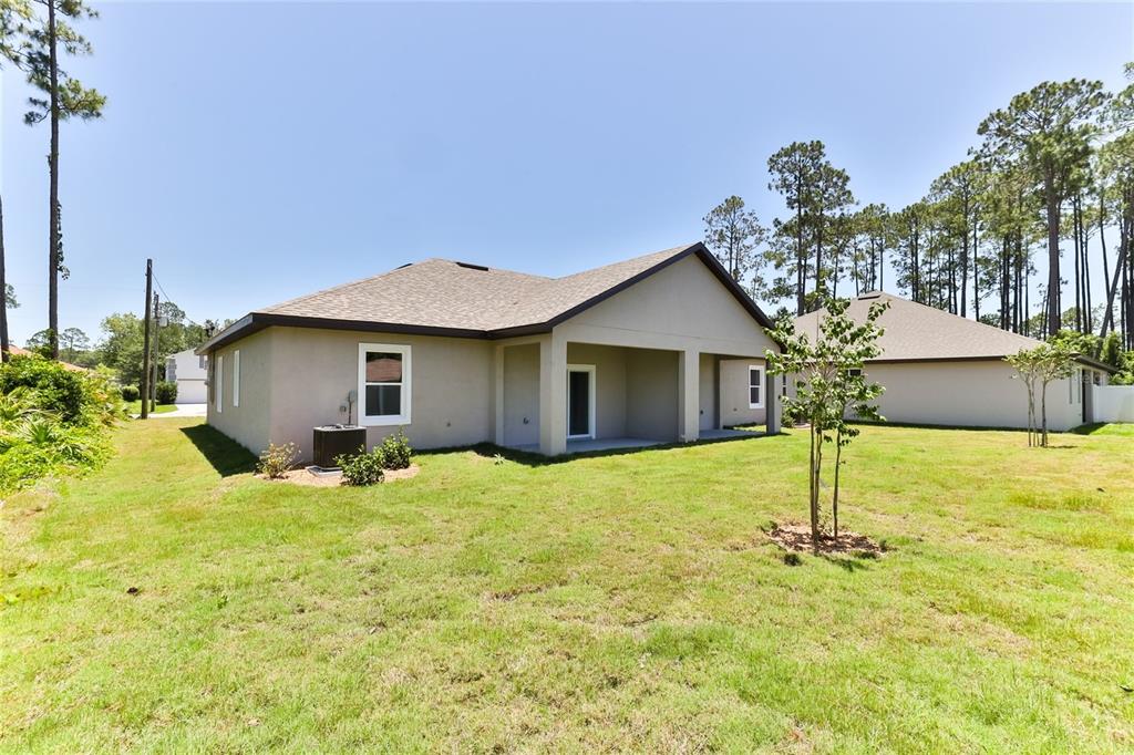 9 Seton Place, Unit A Palm Coast, FL 32164 - Photo 29 of 31 a house with yard in front of it