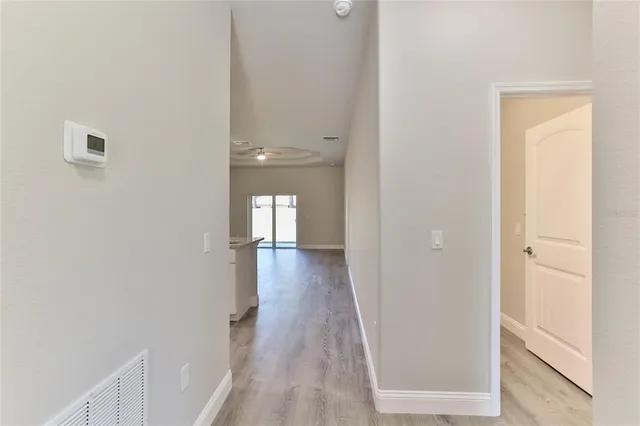 a view of a hallway with wooden floor