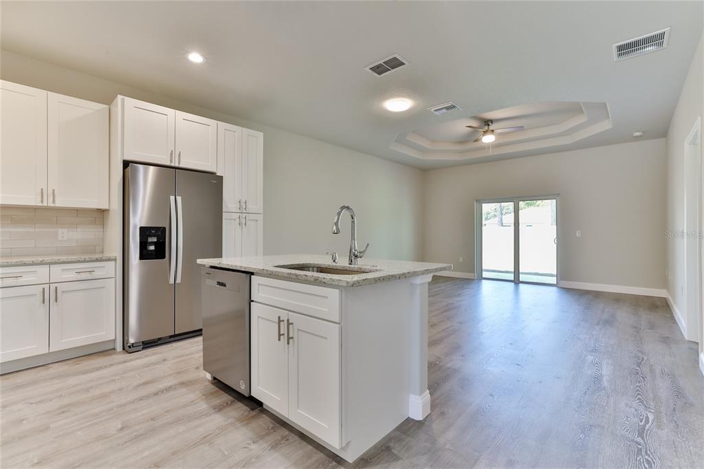 9 Seton Place, Unit A Palm Coast, FL 32164 - Photo 6 of 31 a kitchen with stainless steel appliances granite countertop a sink stove and refrigerator