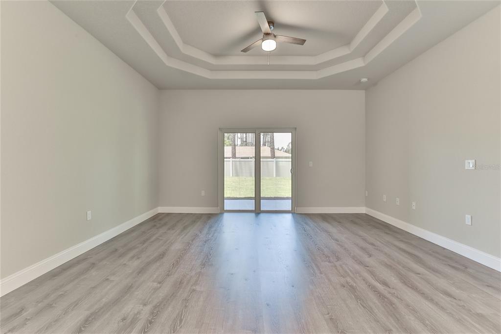 9 Seton Place, Unit A Palm Coast, FL 32164 - Photo 8 of 31 an empty room with wooden floor and windows