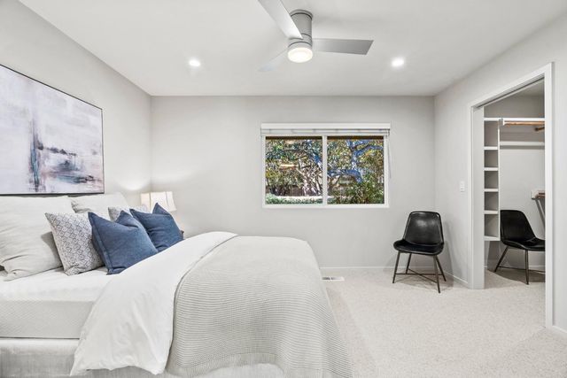 a bedroom with a bed and a chair