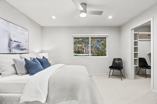 a bedroom with a bed and a chair