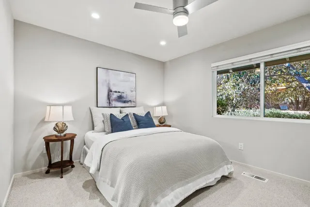 a bedroom with a bed and a painting on the wall