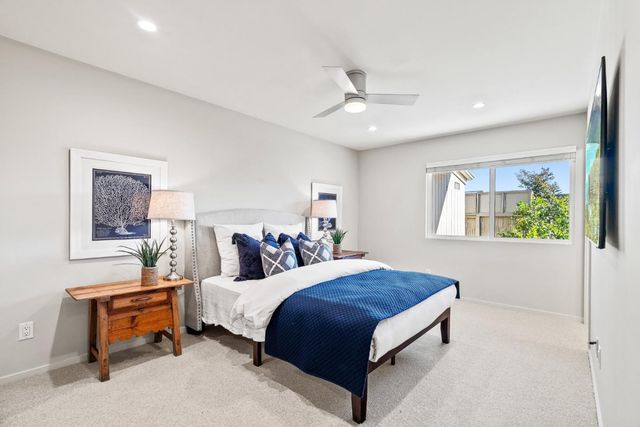 a bedroom with a large bed and a chandelier