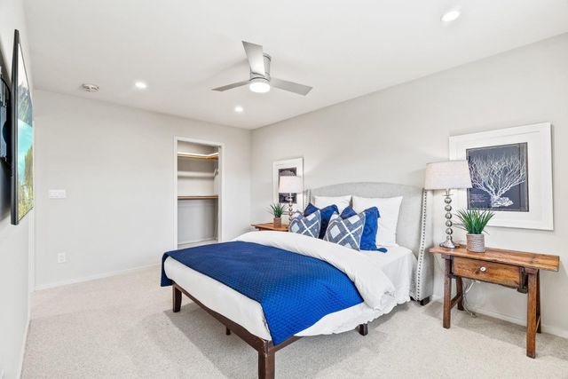 a spacious bedroom with a bed and a table