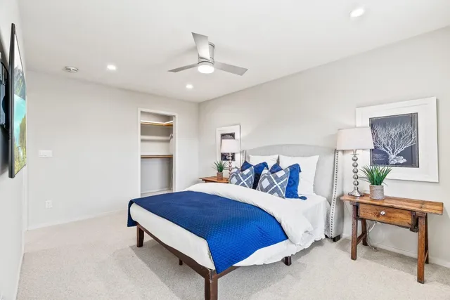 a spacious bedroom with a bed and a table