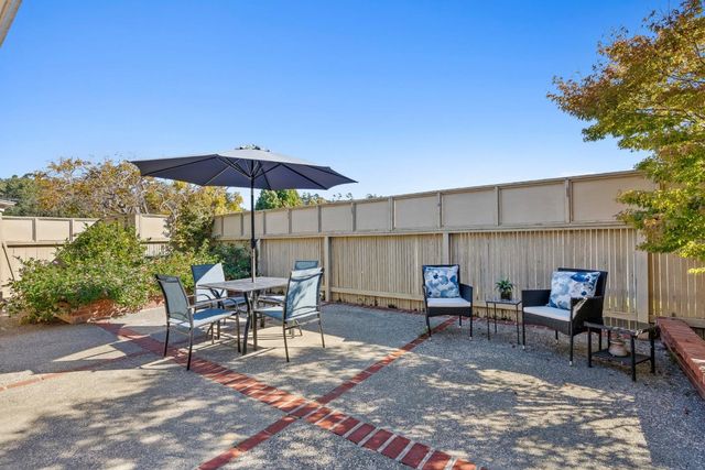 a view of a chairs and table in the patio