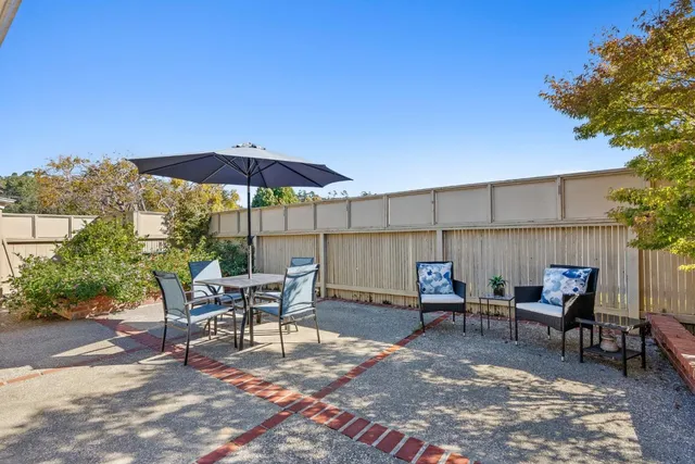 a view of a chairs and table in the patio