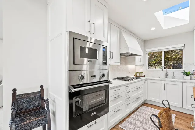 a kitchen with stainless steel appliances a stove microwave and cabinets