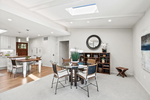 a view of a dining area with furniture and a large window