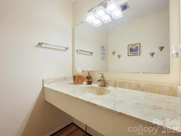 a bathroom with a sink a large mirror and a shower