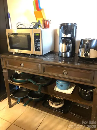 a living room with a stove and a flat screen tv