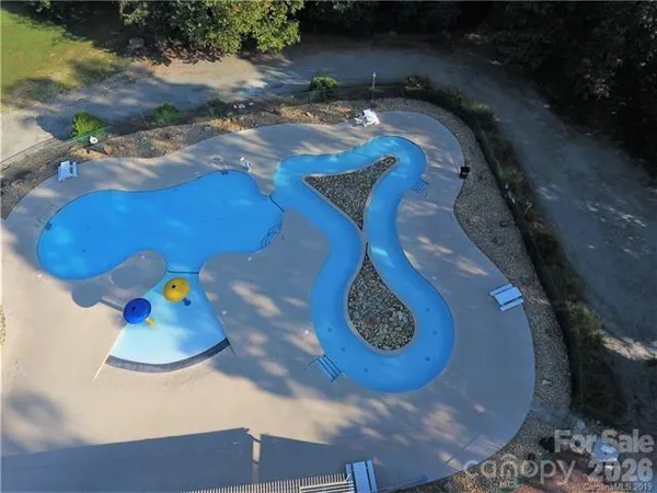 an aerial view of a house swimming pool and outdoor seating
