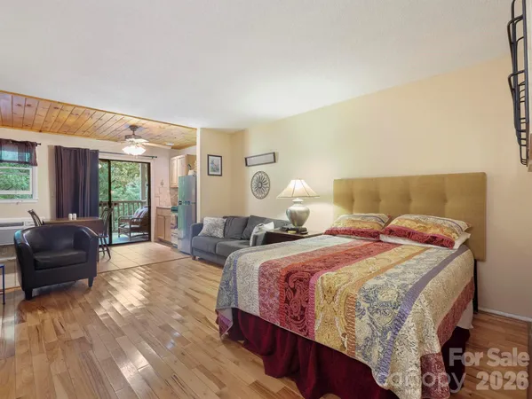 a bedroom with bed and a couch