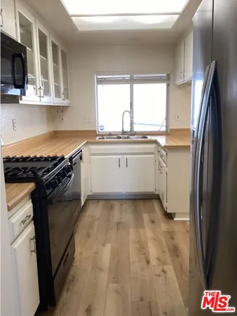 a kitchen with a refrigerator and a stove