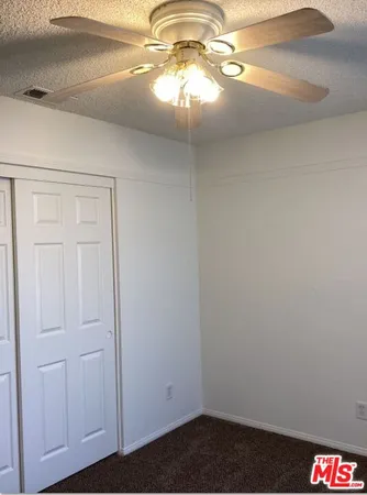 a kitchen with a stove a sink a microwave a refrigerator and cabinets