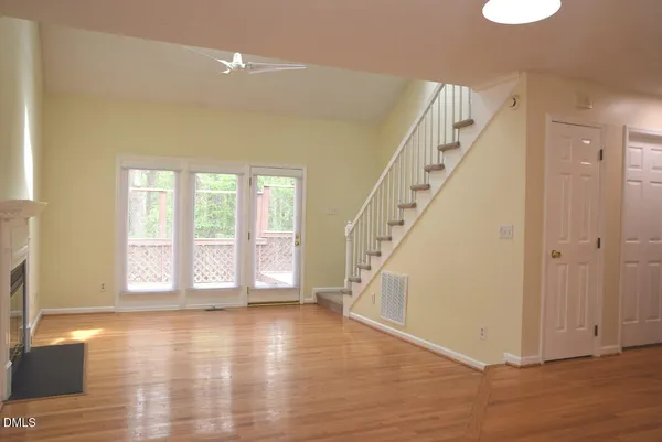 a view of an entryway with wooden floor and door