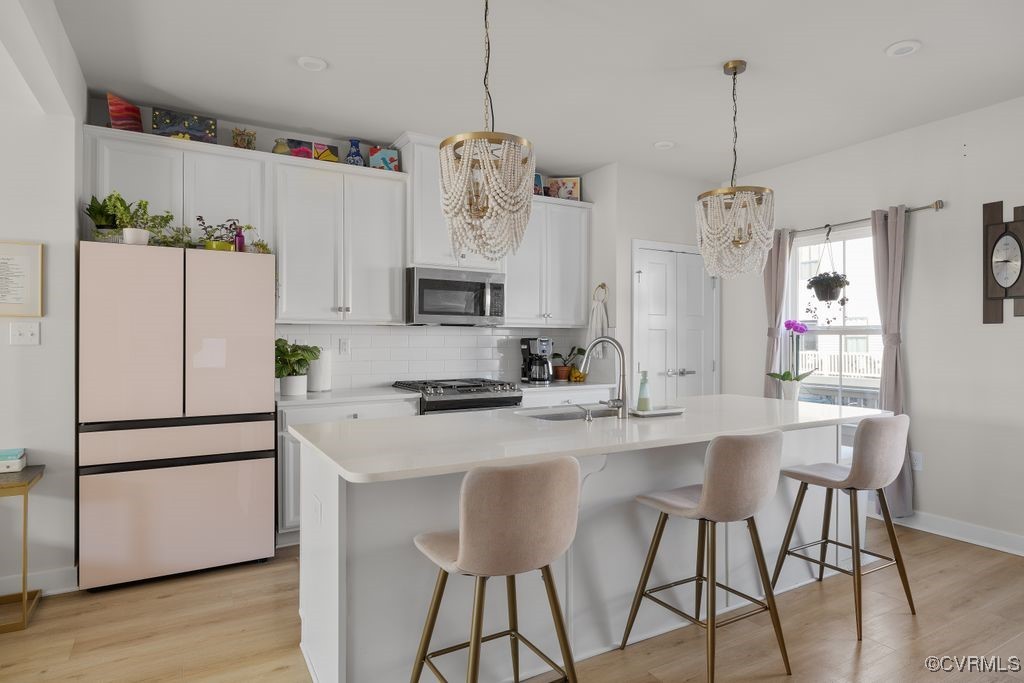 2117 Borough Ridge Street Richmond, VA 23225 - Photo 9 of 27 Kitchen featuring light wood finished floors, stai