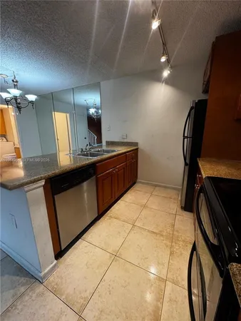 a kitchen with a sink cabinets and appliances