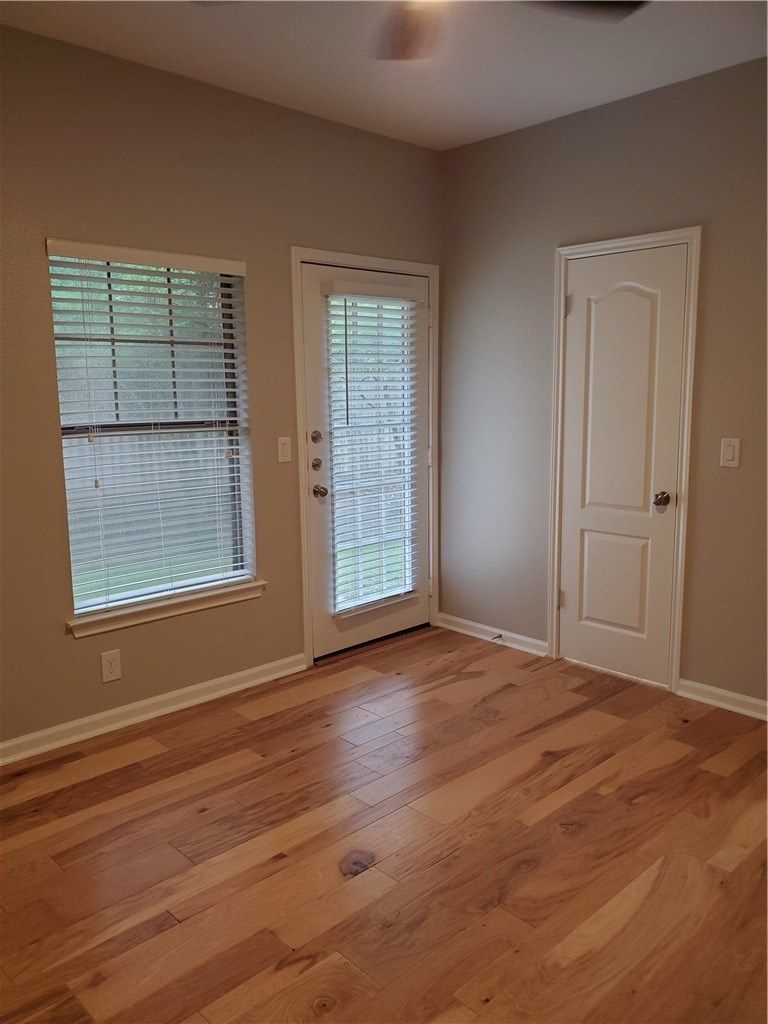 11203 Ranch Road 2222, Unit 302 Austin, TX 78732 - Photo 7 of 18 1st floor 2nd bedroom with door to back patio and walk in closet