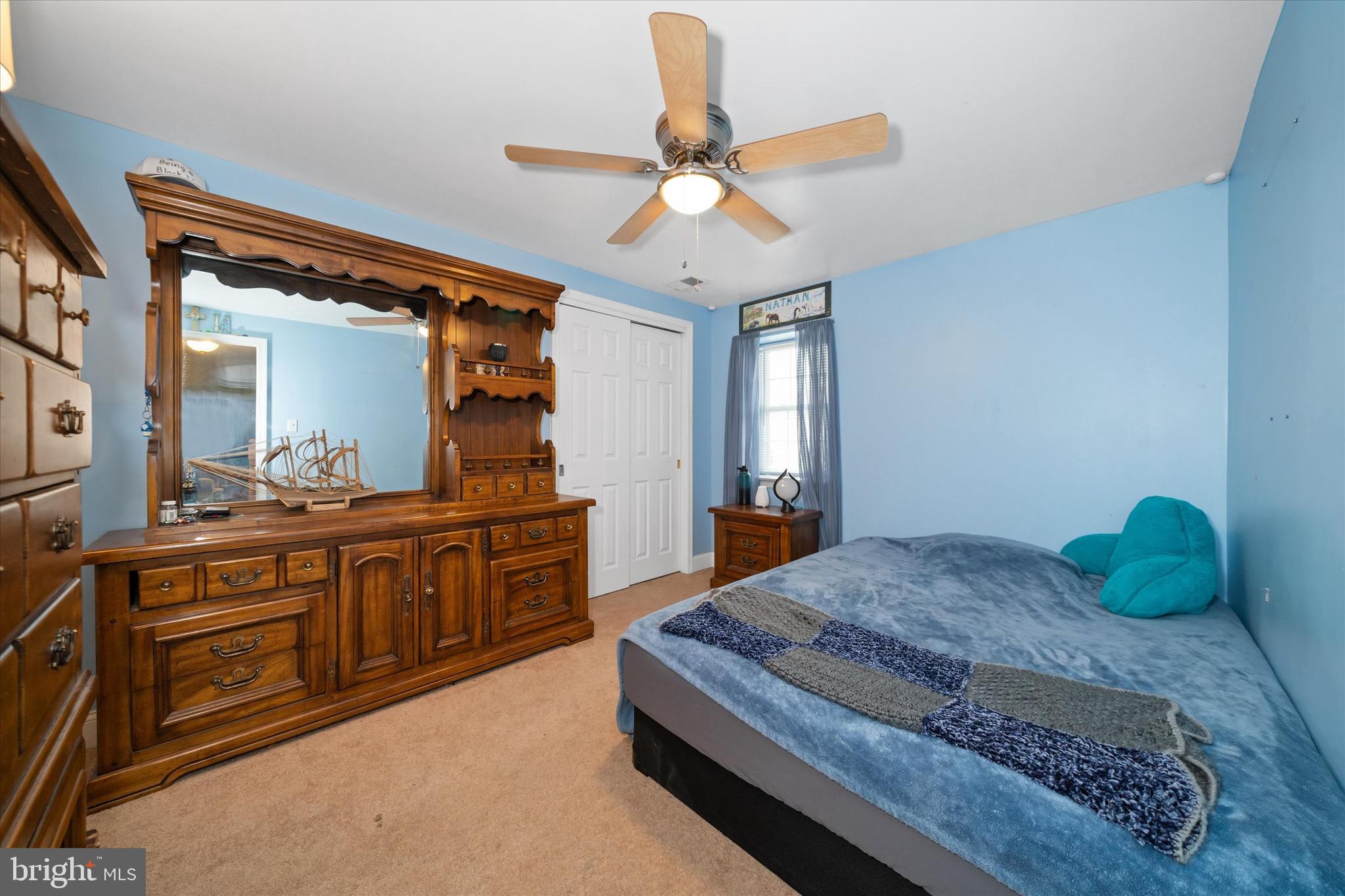 1331 Cherry Tree Road Aston, PA 19014 - Photo 28 of 40 a spacious bedroom with a bed a chandelier and a dresser